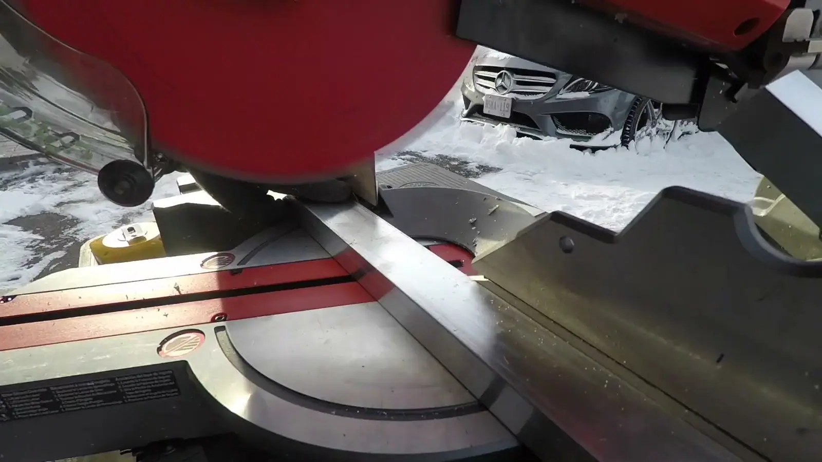 A mitre saw cutting aluminium angle in the workshop.
