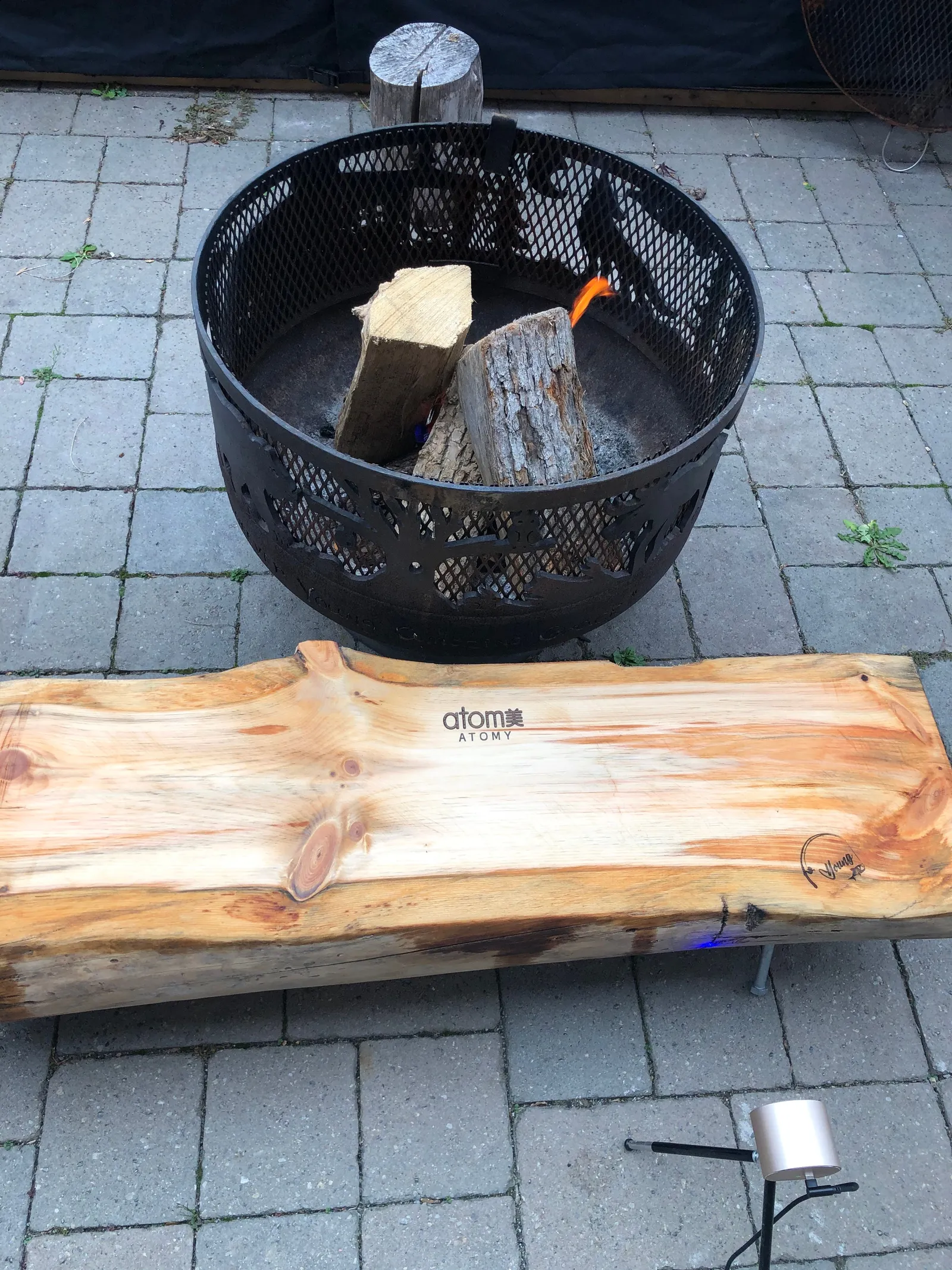 A live-edge slab beside a fire pit on a patio.