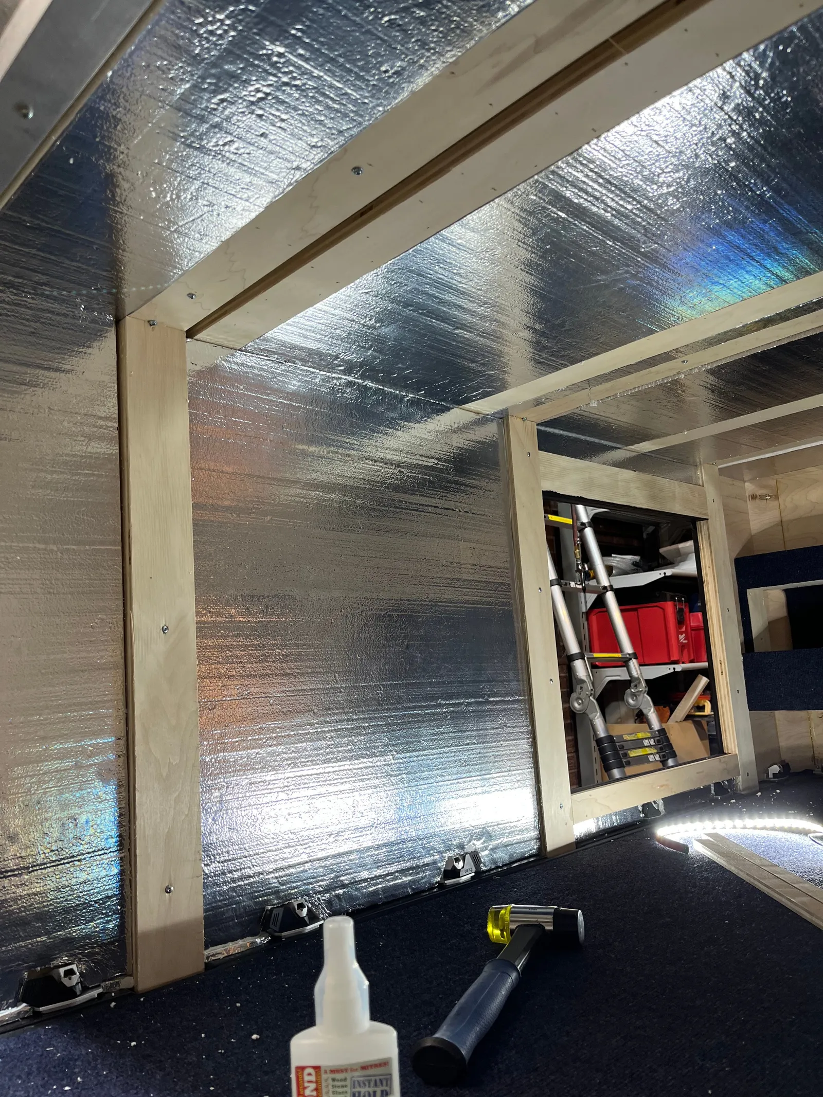 The inside of the cabin lined with reflective insulation, with framing.